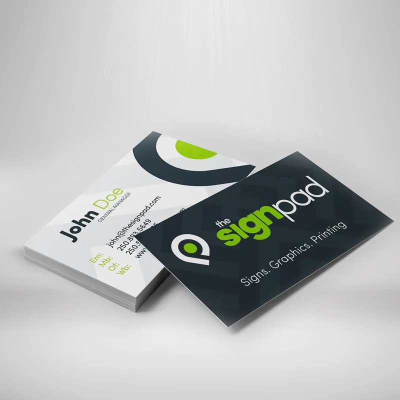 Business cards mockup showing the front and back of a printed card and a stack of cards